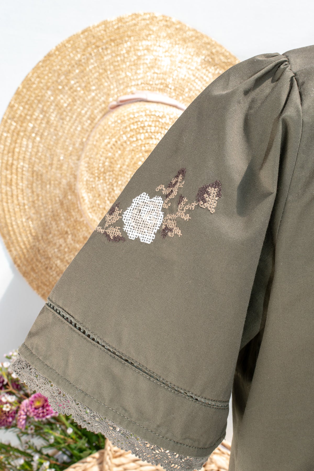 up close view of lace and embroidery. french style top. 