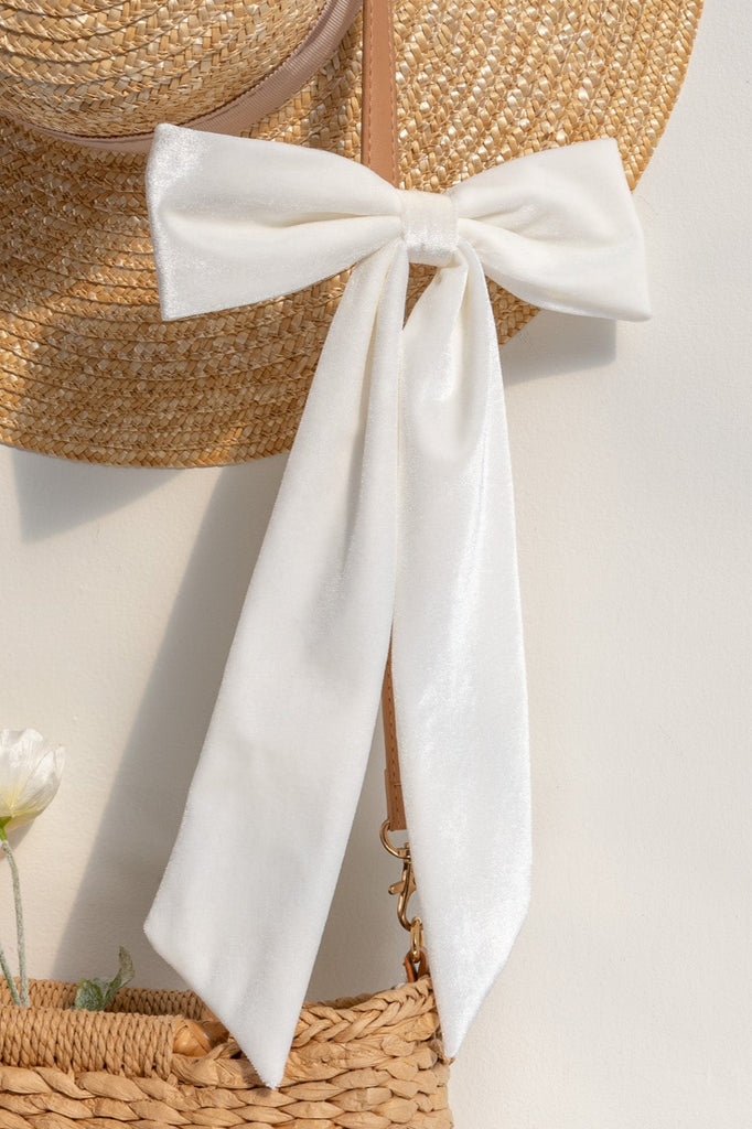 french hair accessories for feminine style. a white bow with clip for hair. french style. 