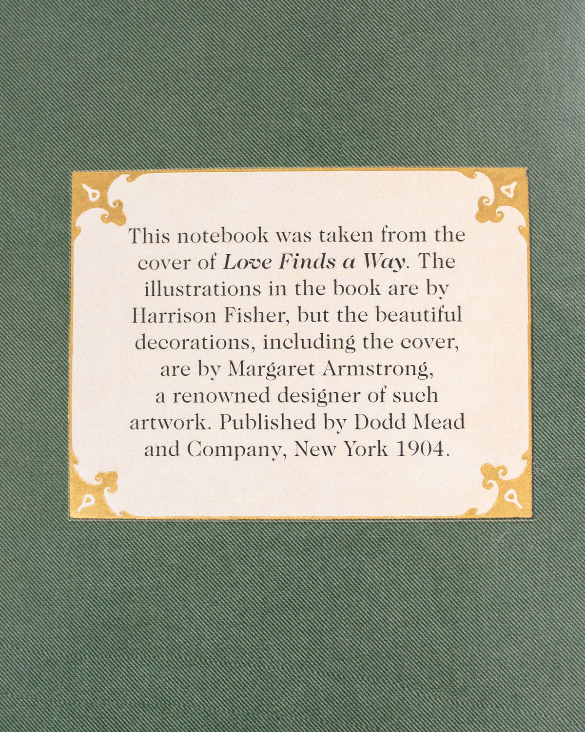 Back cover of a green vintage notebook with a printed label on textured green cover, back detail view.