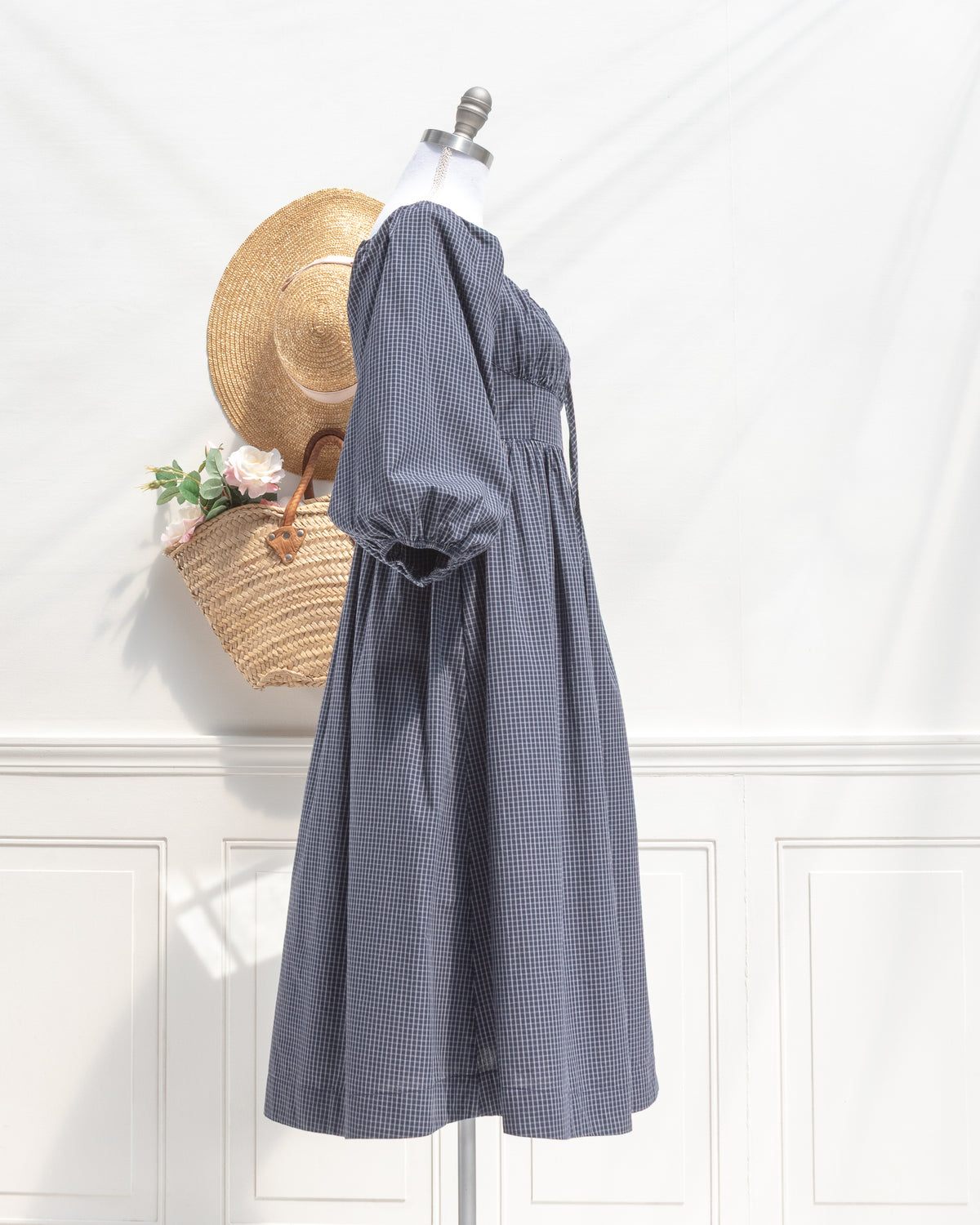 Navy check cotton midi dress with balloon sleeves and gathered waist, mannequin side view.