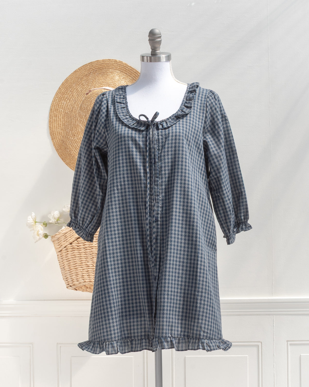 Navy gingham mini dress with ruffle collar and tie front, a classic wardrobe staple, mannequin front view.