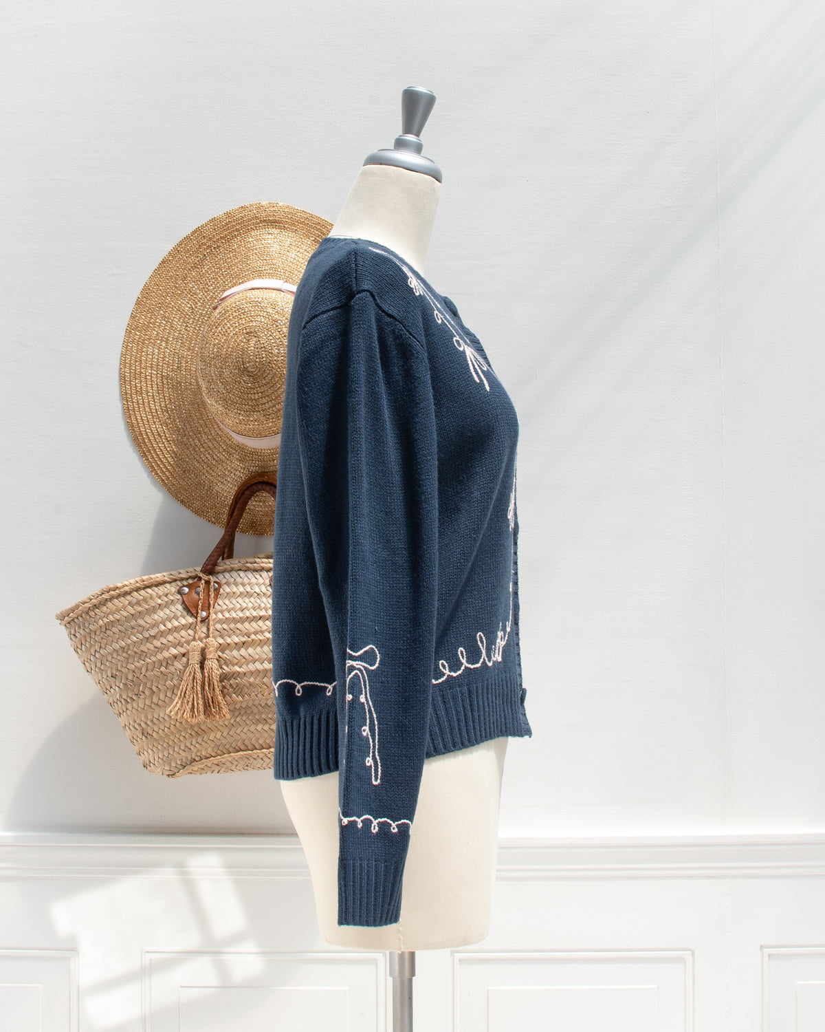 Feminine style cardigan. French girl style. Blue cardigan with whimsical bow detail embroidery. side view. Amantine