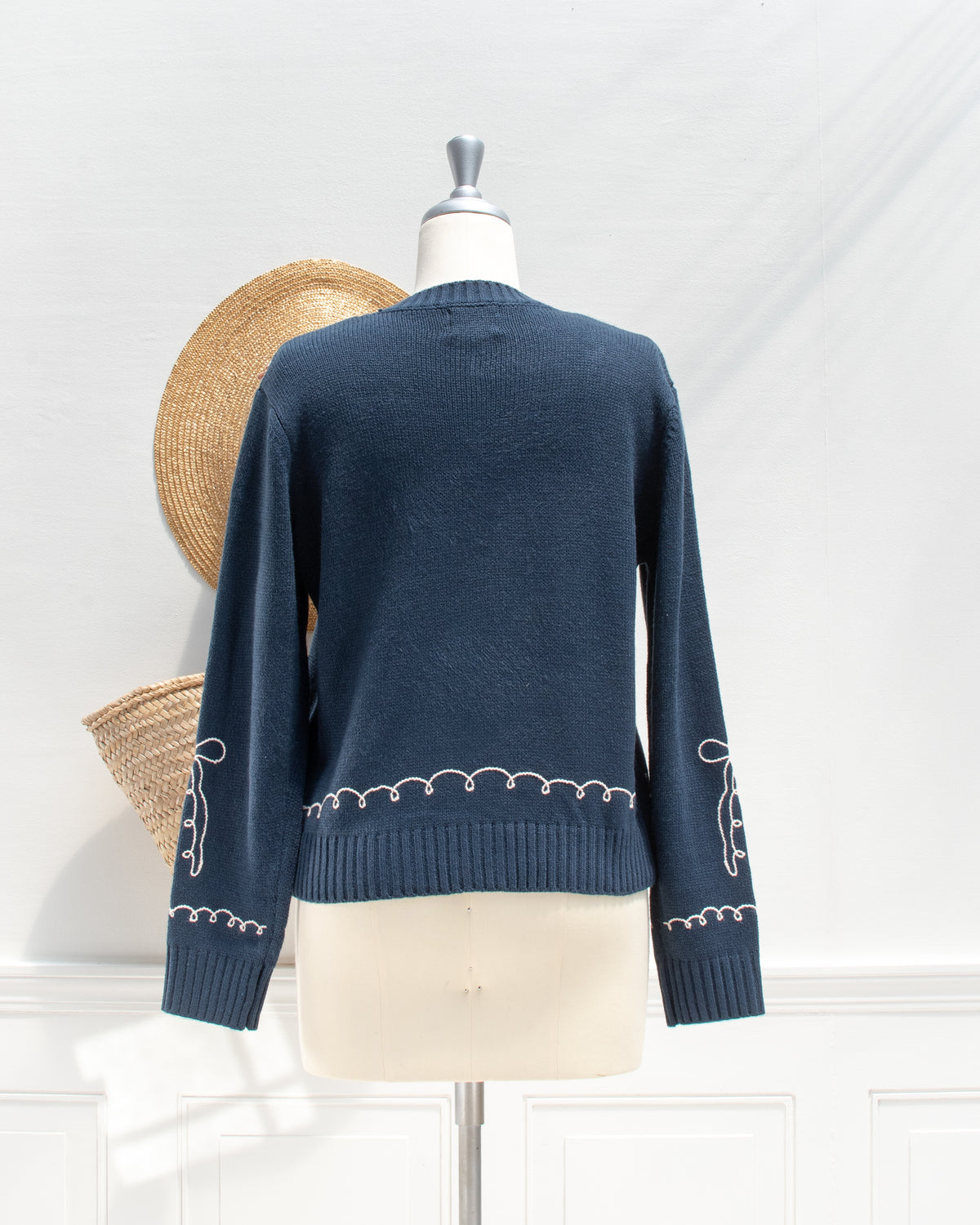 Feminine style cardigan. French girl style. Blue cardigan with whimsical bow detail embroidery. Back view. Amantine