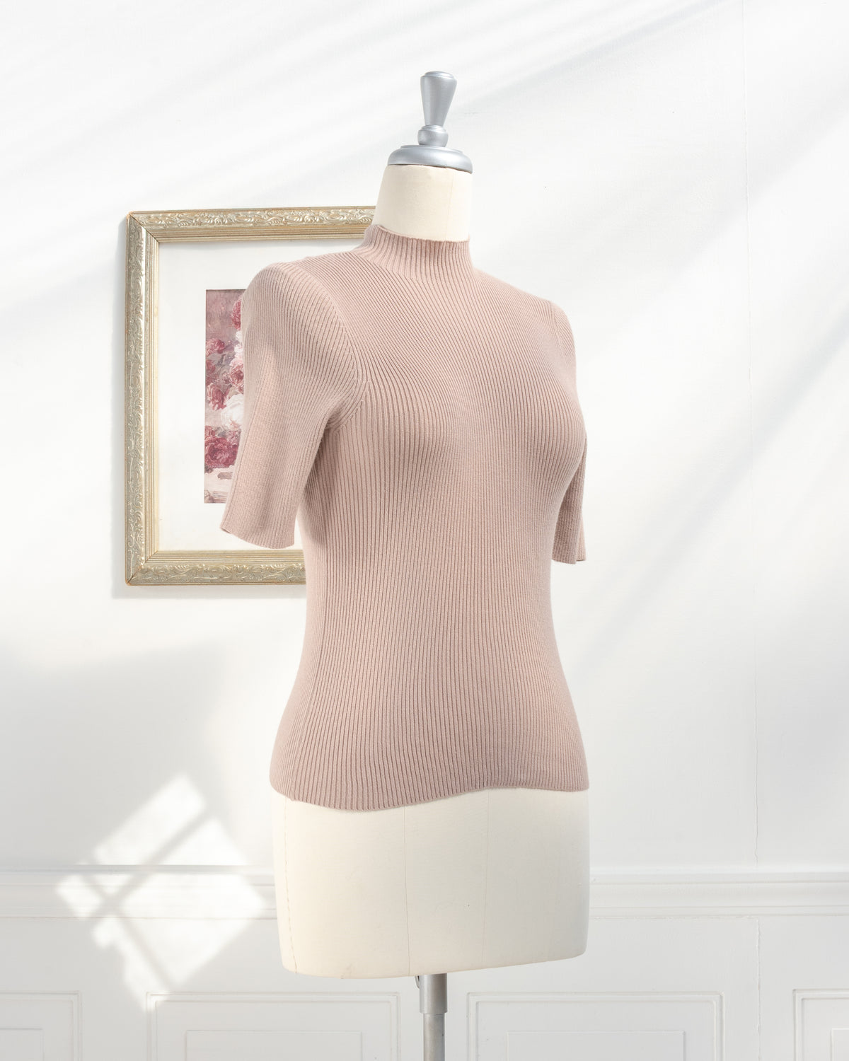 Taupe ribbed knit top with close fit and short sleeves on a mannequin, feminine style, three quarter view.
