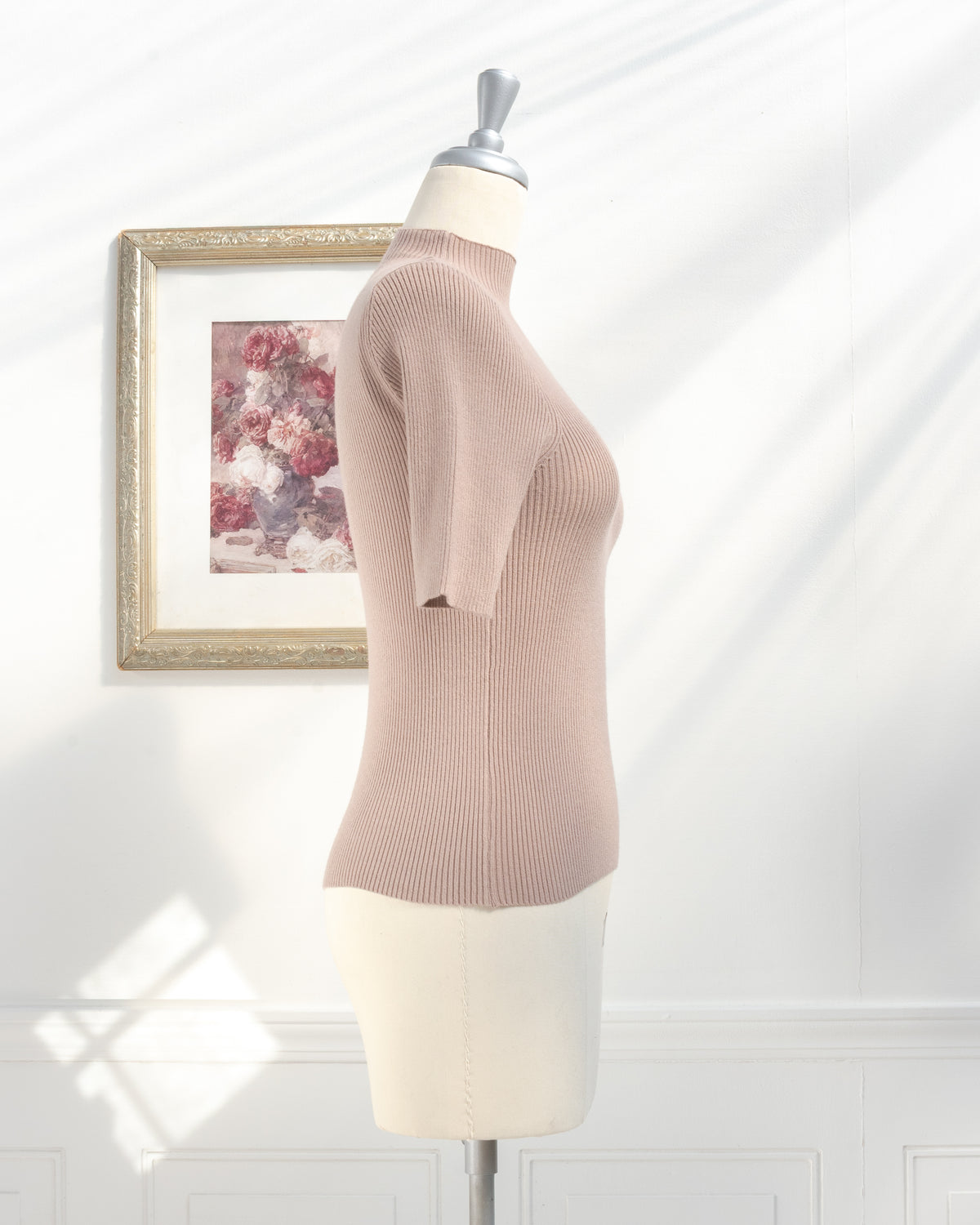 Taupe ribbed knit top with short sleeves and mock neck on a mannequin, classic fall season, side view.
