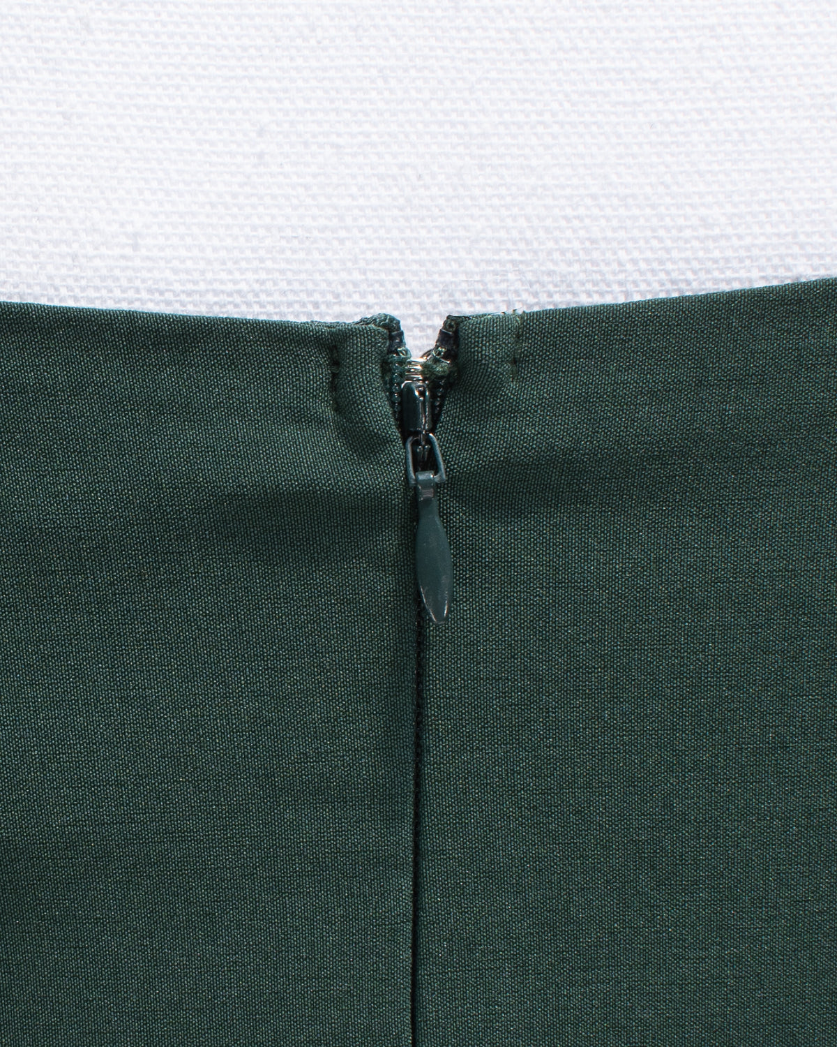 Close up of hidden center back seam zipper.