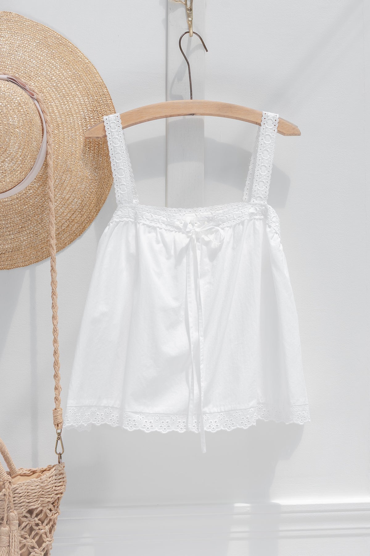 Timeless white cotton chemise top with eyelet hem trim, ribbon drawstring neckline and relaxed babydoll fit, front view.