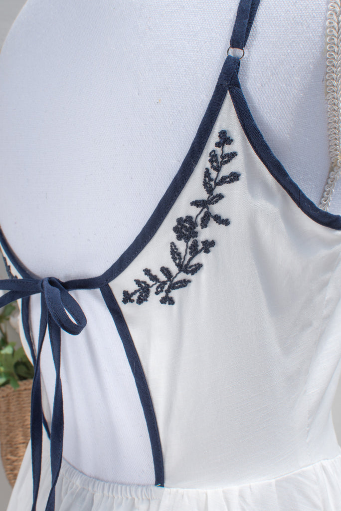 white dress with blue accents White Cotton Embroidered Midi Dress – Navy Trim Floral Border