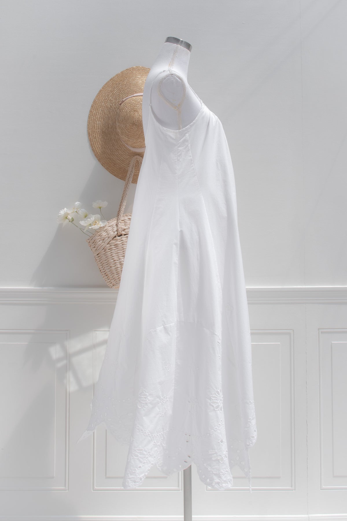 White cotton eyelet midi dress with cutwork hem side view.