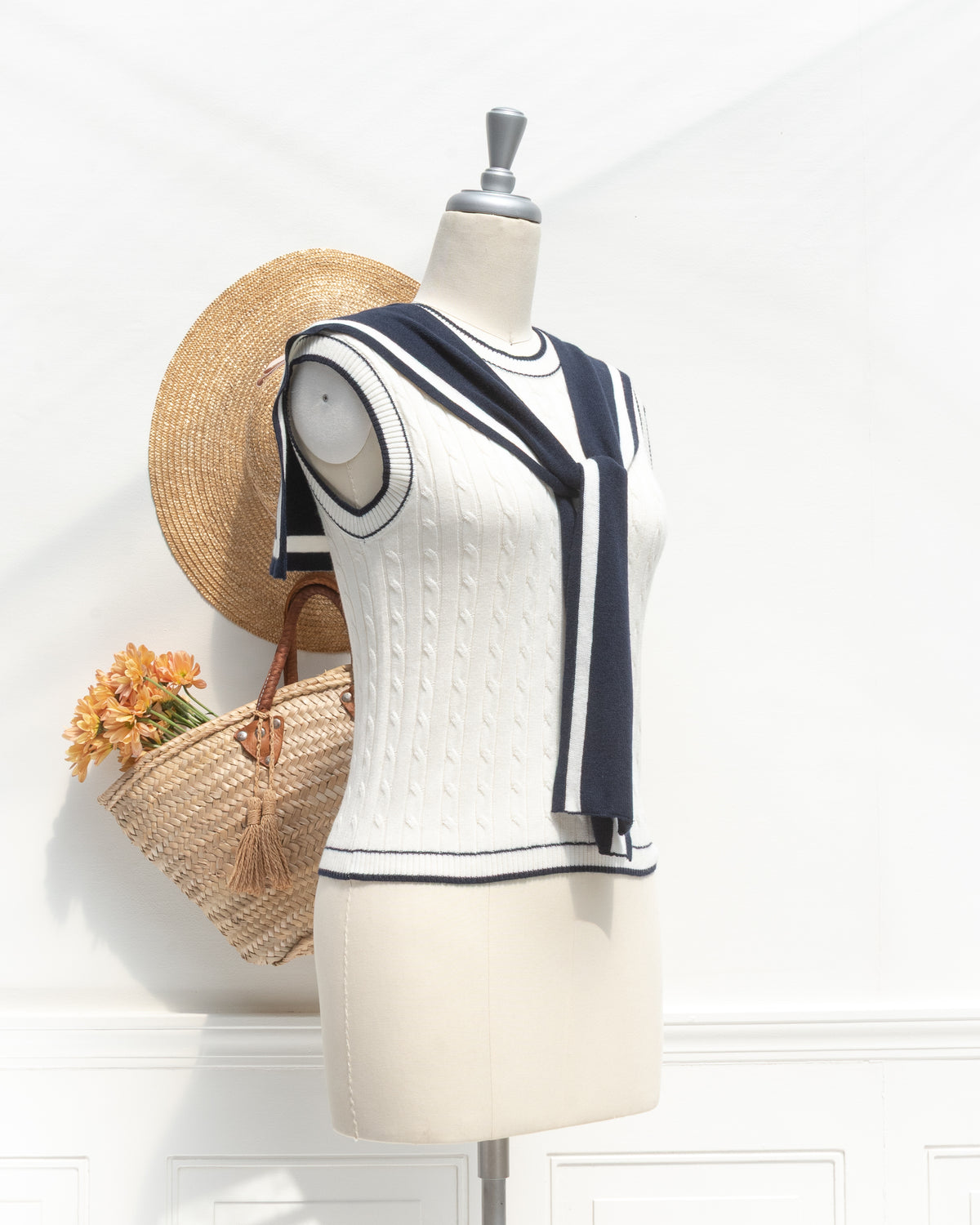 White cable knit sailor top with front tie collar, a feminine vintage inspired look, mannequin three quarter view.
