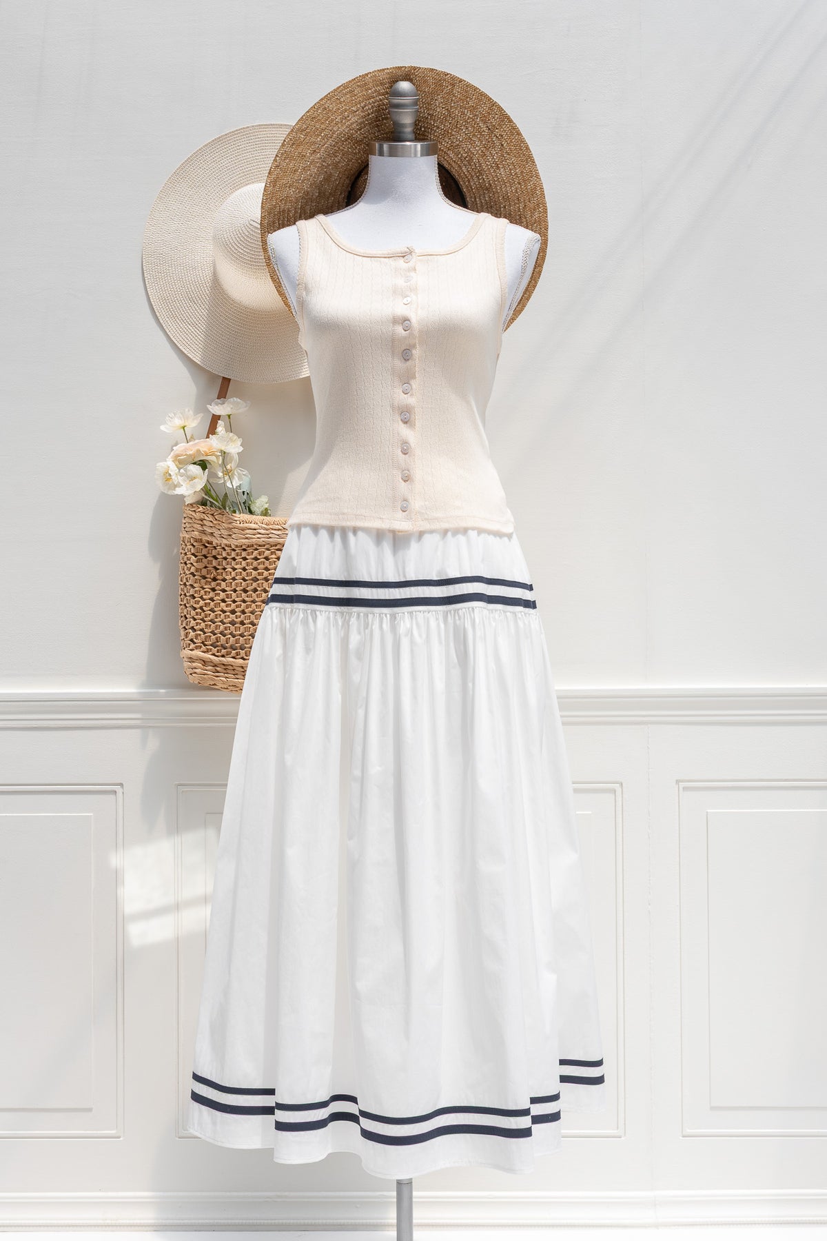 White cotton navy stripe midi skirt styled with cream knit top, front view.